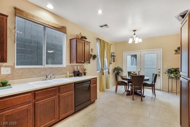 kitchen with sink, black dishwasher, decorative light fixtures, french doors, and a chandelier