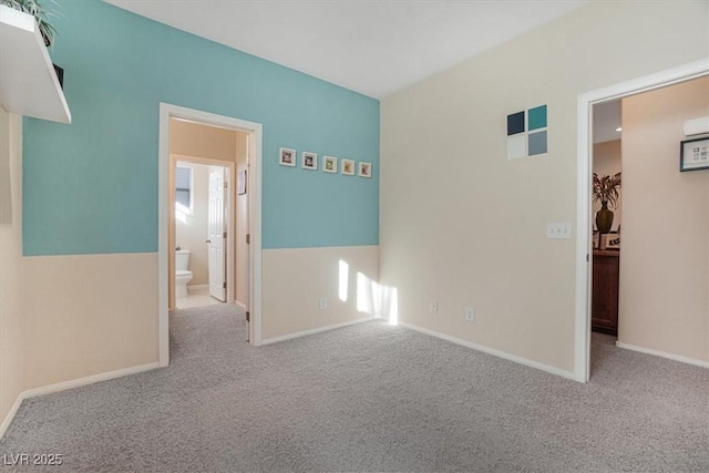 unfurnished room featuring light carpet