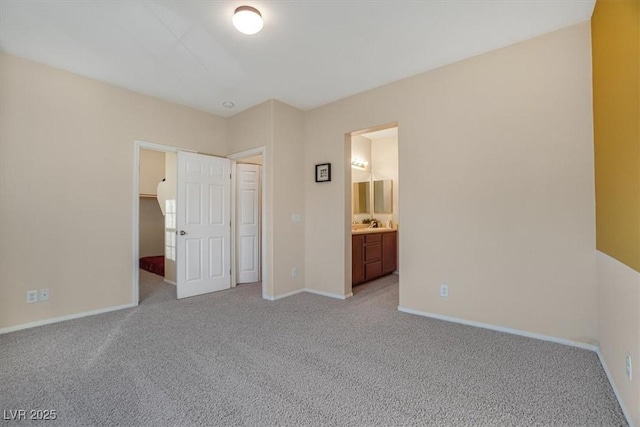 unfurnished bedroom featuring connected bathroom and light colored carpet