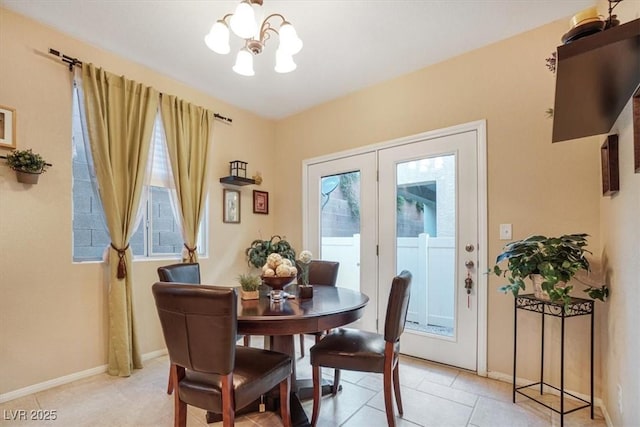 tiled dining space with an inviting chandelier and french doors