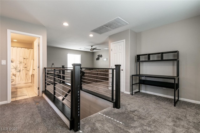 interior space with ensuite bath and ceiling fan