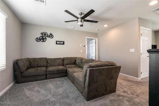 living room with ceiling fan and dark colored carpet