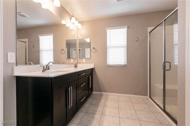 bathroom featuring tile patterned flooring, vanity, and a shower with door