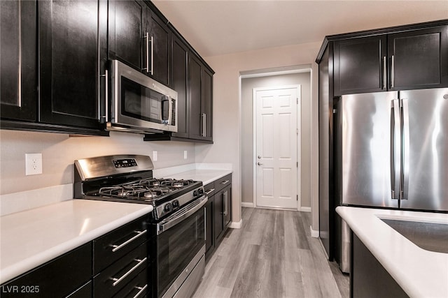 kitchen featuring light wood-type flooring and appliances with stainless steel finishes