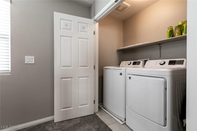 washroom with independent washer and dryer and light tile patterned flooring