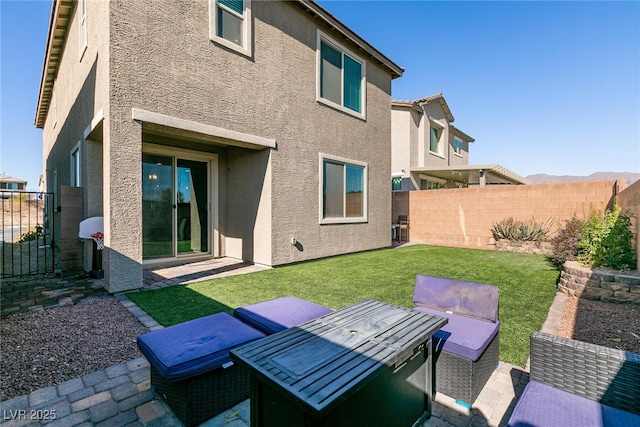 back of property featuring a lawn and a patio area