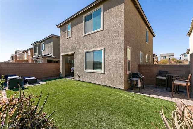 back of property with a patio and a lawn