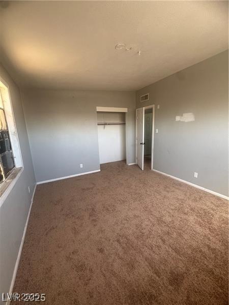 2127 Crawford St, North Las Vegas, NV 89030 - unfurnished bedroom with carpet and a closet