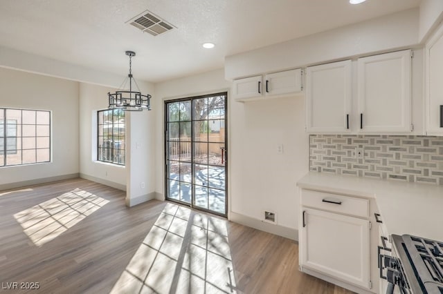 dining space with an inviting chandelier and light hardwood / wood-style flooring