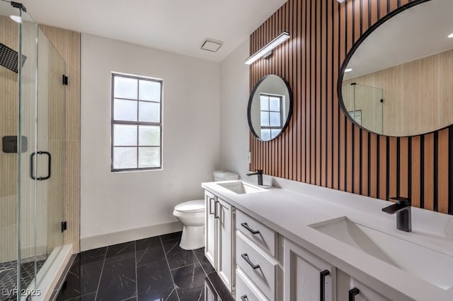 bathroom featuring toilet, vanity, and an enclosed shower