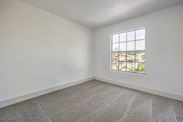 unfurnished room featuring carpet floors and a textured ceiling