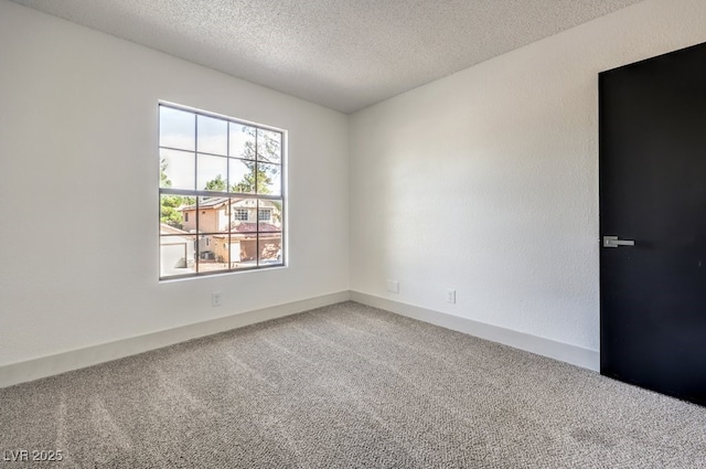 unfurnished room featuring carpet floors and a textured ceiling