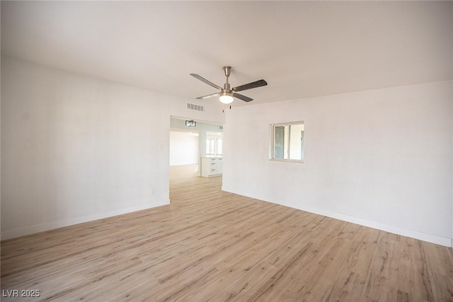 unfurnished room with ceiling fan and light wood-type flooring