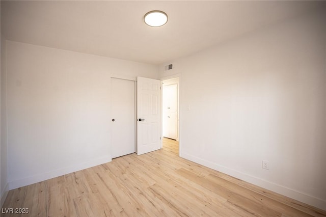 spare room with light hardwood / wood-style floors