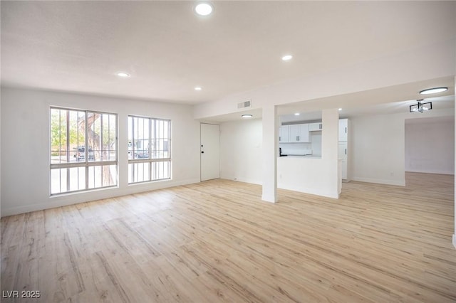 unfurnished living room featuring light wood-type flooring