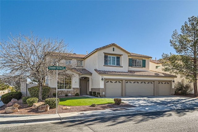 mediterranean / spanish home with a garage and a front yard