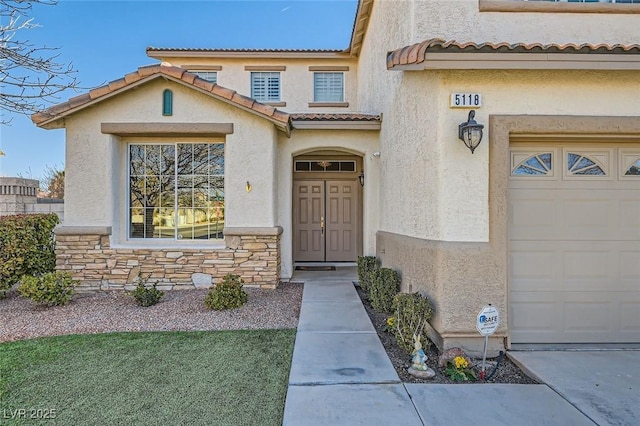 doorway to property with a garage