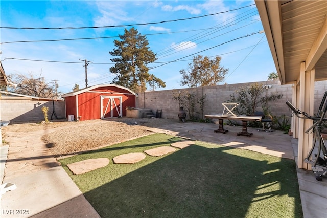 view of yard featuring a shed and a patio area