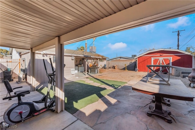 view of patio featuring a shed