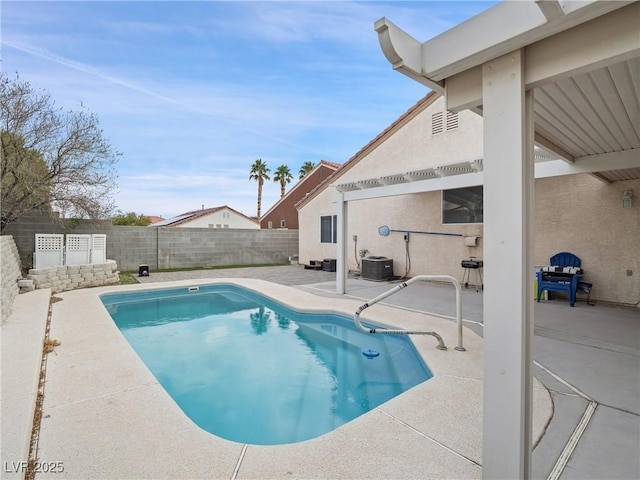 view of pool with cooling unit and a patio area