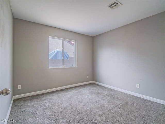 unfurnished room with visible vents, baseboards, and carpet flooring