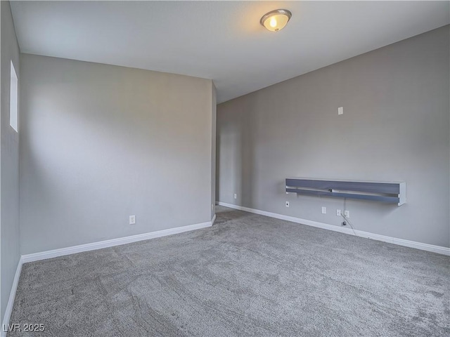 empty room with baseboards and carpet floors