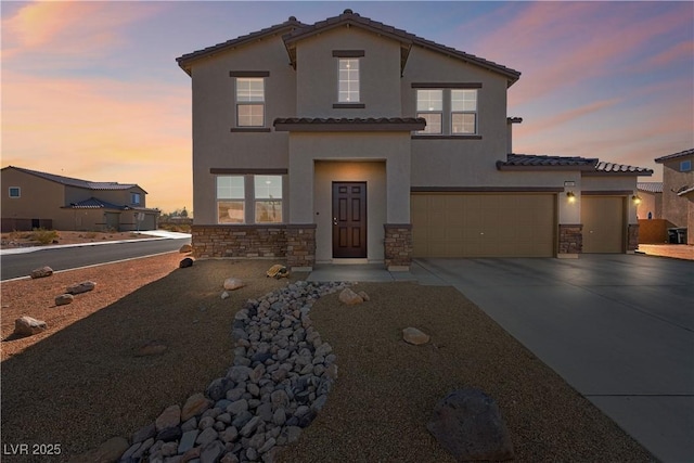 mediterranean / spanish house with a garage