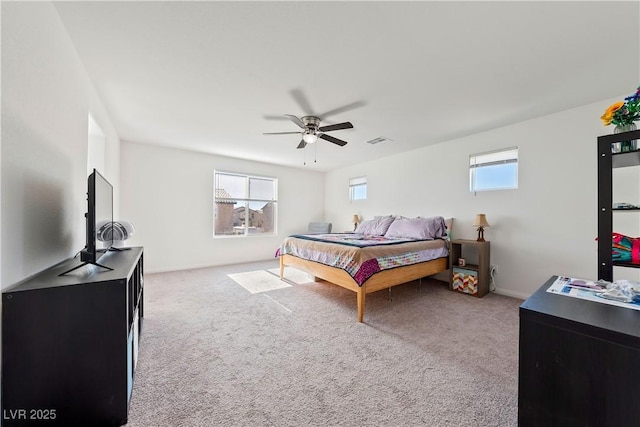 bedroom featuring light carpet and ceiling fan