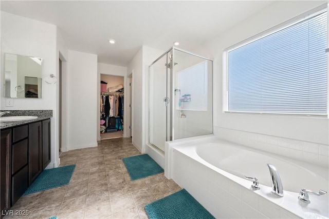 bathroom featuring vanity and shower with separate bathtub