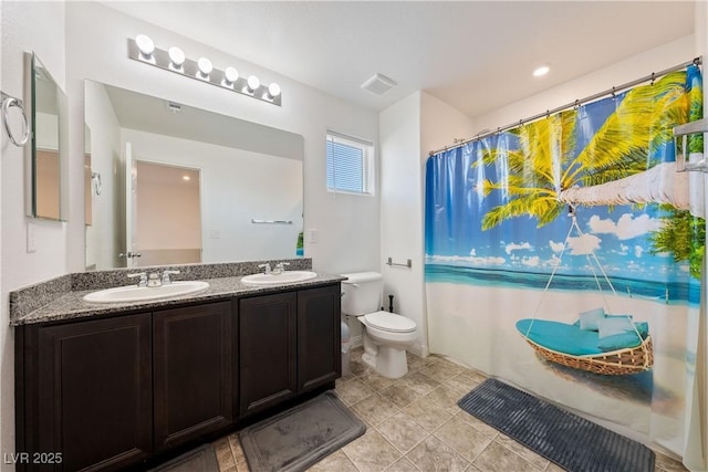 bathroom featuring curtained shower, toilet, and vanity