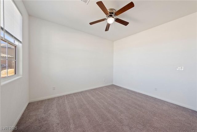 spare room with ceiling fan and carpet