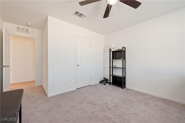 unfurnished bedroom with ceiling fan and light carpet