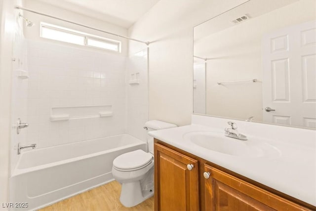 full bathroom featuring shower / bath combination, hardwood / wood-style floors, toilet, and vanity