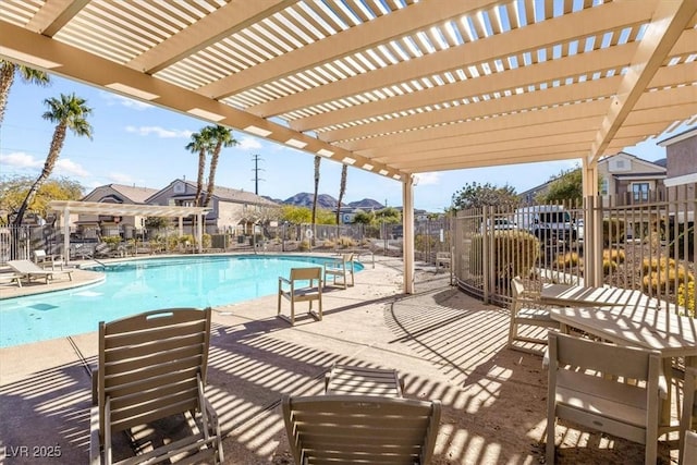 view of swimming pool with a patio and a pergola