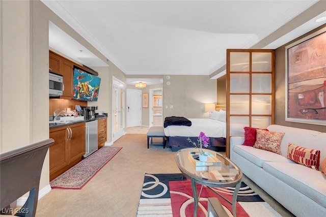 living room featuring light carpet, ornamental molding, and sink