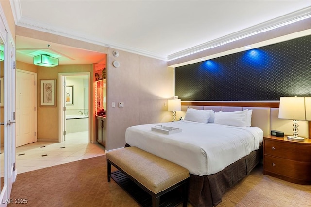 tiled bedroom featuring ensuite bath and ornamental molding