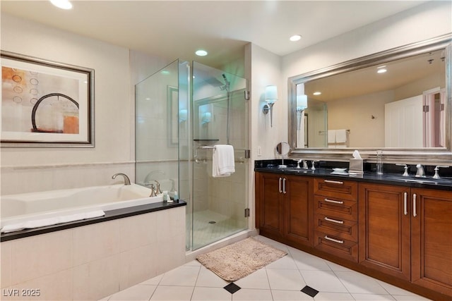 bathroom featuring vanity, tile patterned flooring, and shower with separate bathtub