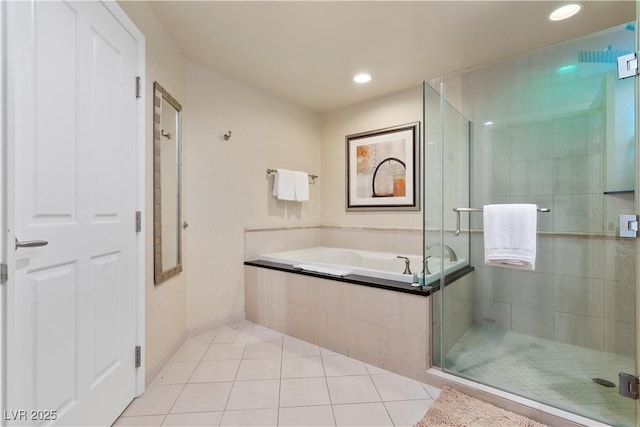 bathroom with tile patterned floors and shower with separate bathtub