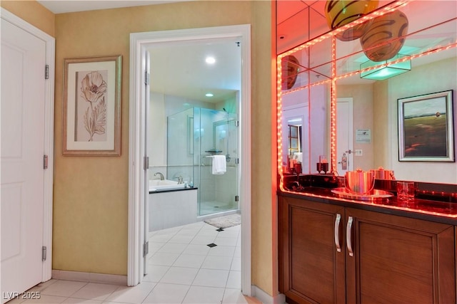 bathroom featuring a shower with shower door, vanity, and tile patterned floors