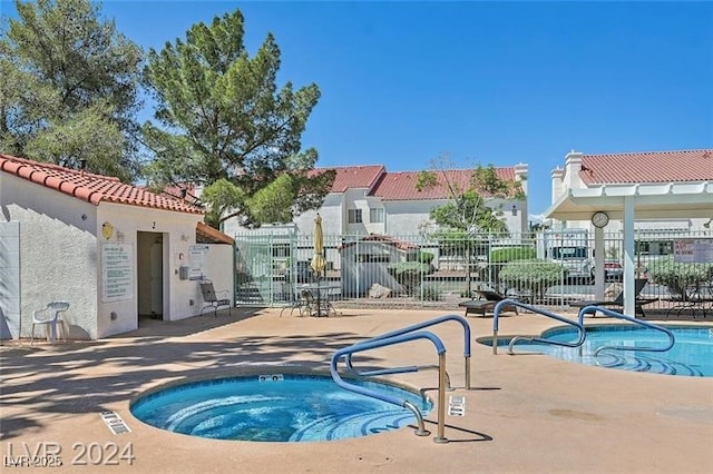 view of swimming pool featuring a patio area, a hot tub, and a pergola