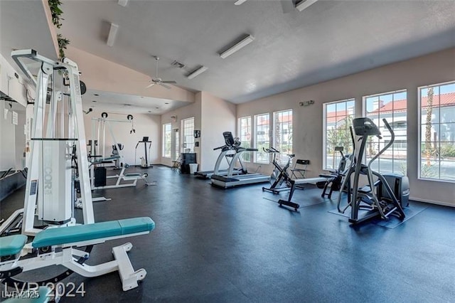 gym with ceiling fan and lofted ceiling