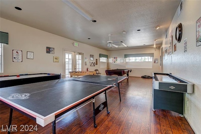 recreation room featuring ceiling fan, a textured ceiling, french doors, dark hardwood / wood-style flooring, and pool table