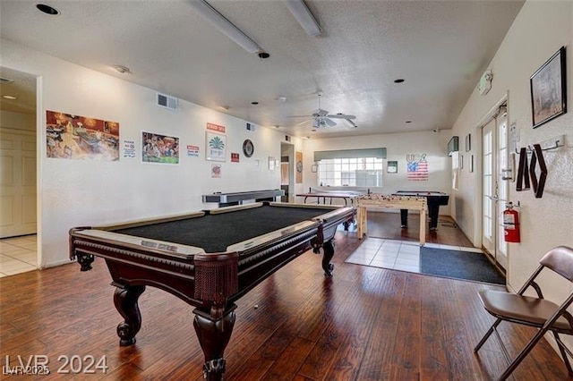 rec room with ceiling fan, wood-type flooring, billiards, and a textured ceiling