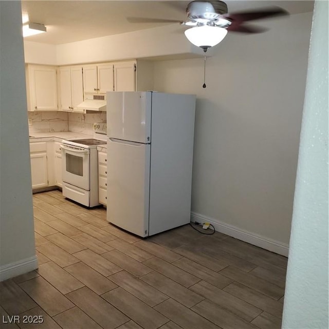 kitchen featuring tasteful backsplash, ceiling fan, white appliances, and white cabinetry