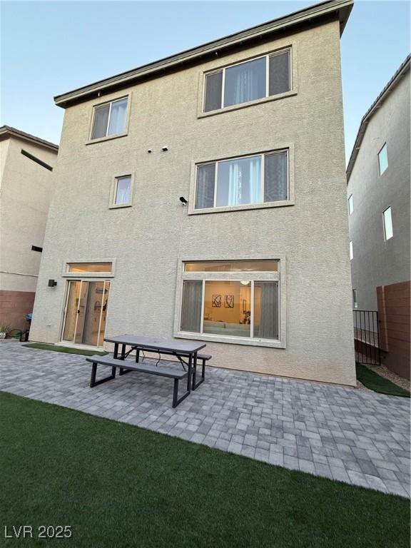 rear view of house with a patio area and a yard