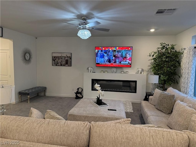 living room with ceiling fan and carpet