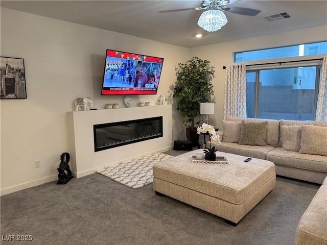 living room featuring ceiling fan and dark carpet