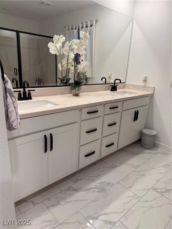 bathroom with a shower with shower door and vanity