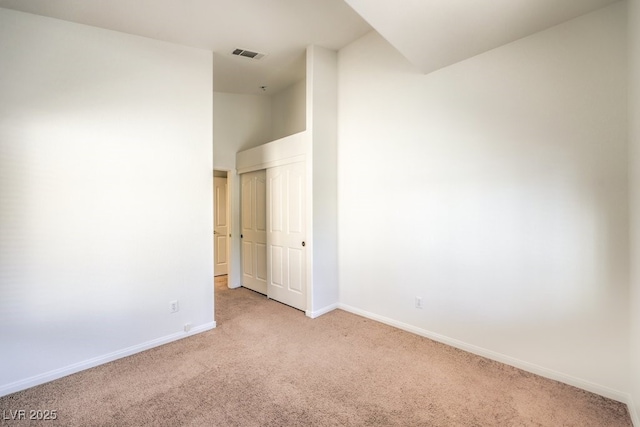 unfurnished room with light carpet