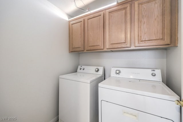 washroom with washing machine and dryer and cabinets